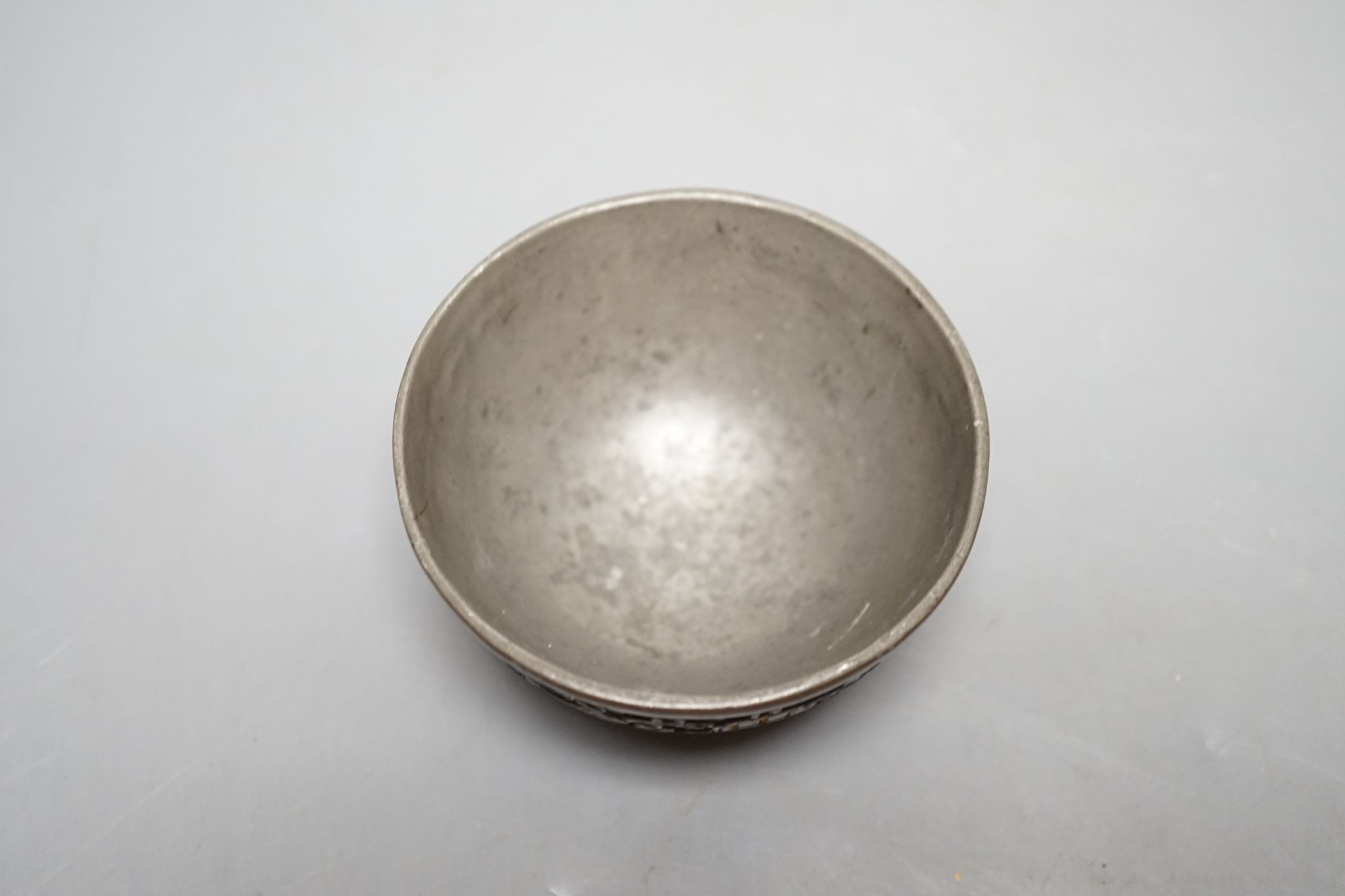 A Chinese coconut cup, 18th/19th century., 8.5 cms diameter.